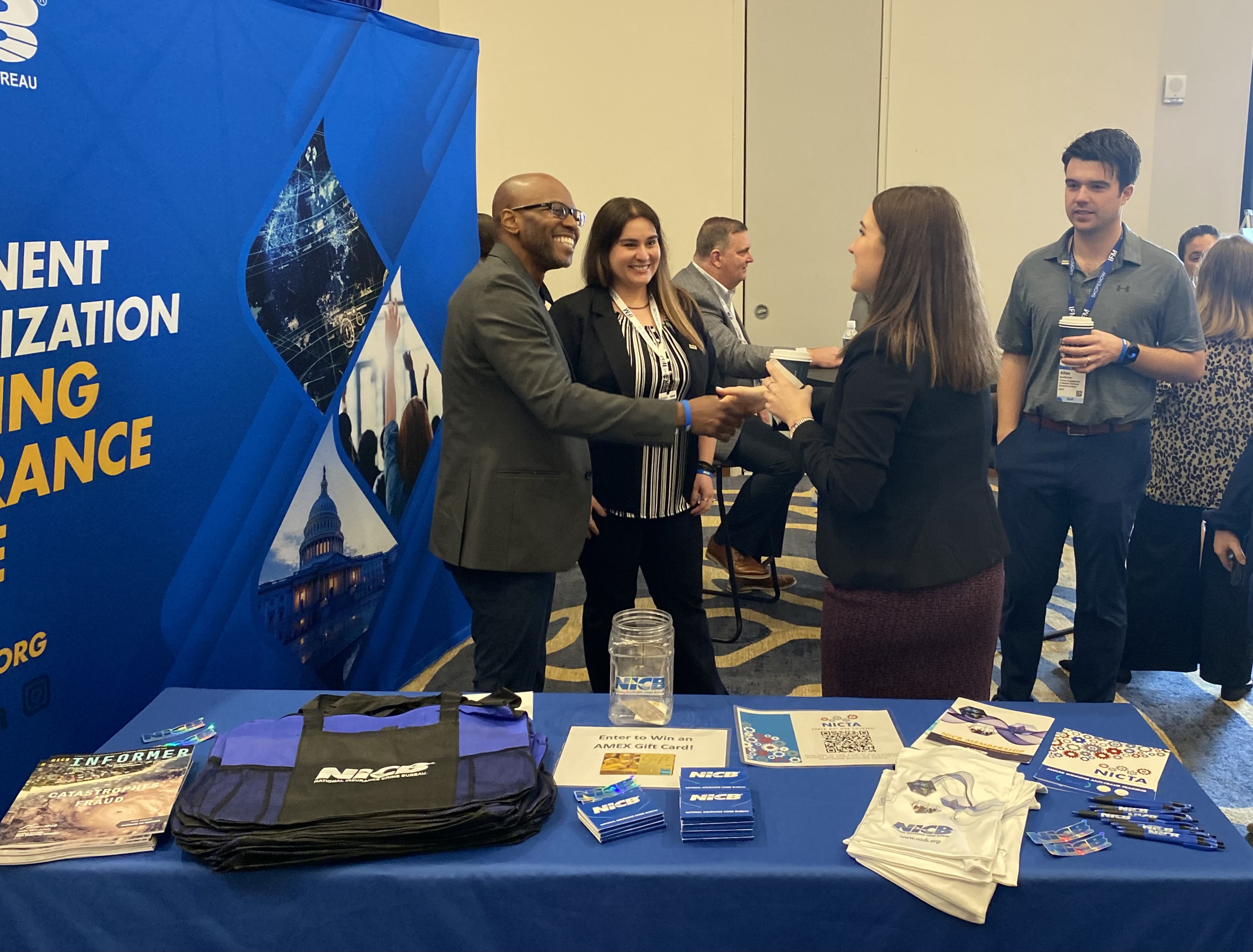 NICB's Membership team greeting a visitor to their booth