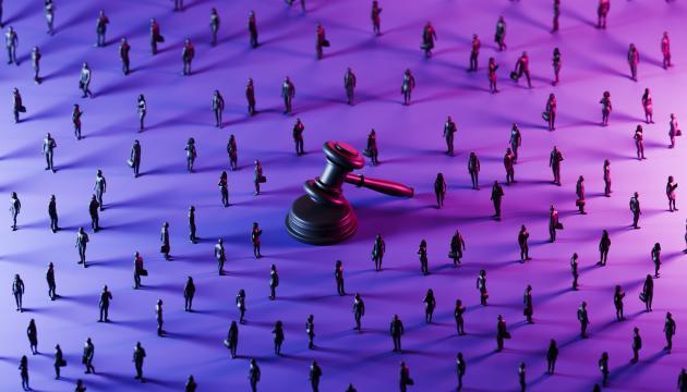 Judge's Gavel surrounded by miniatures of people